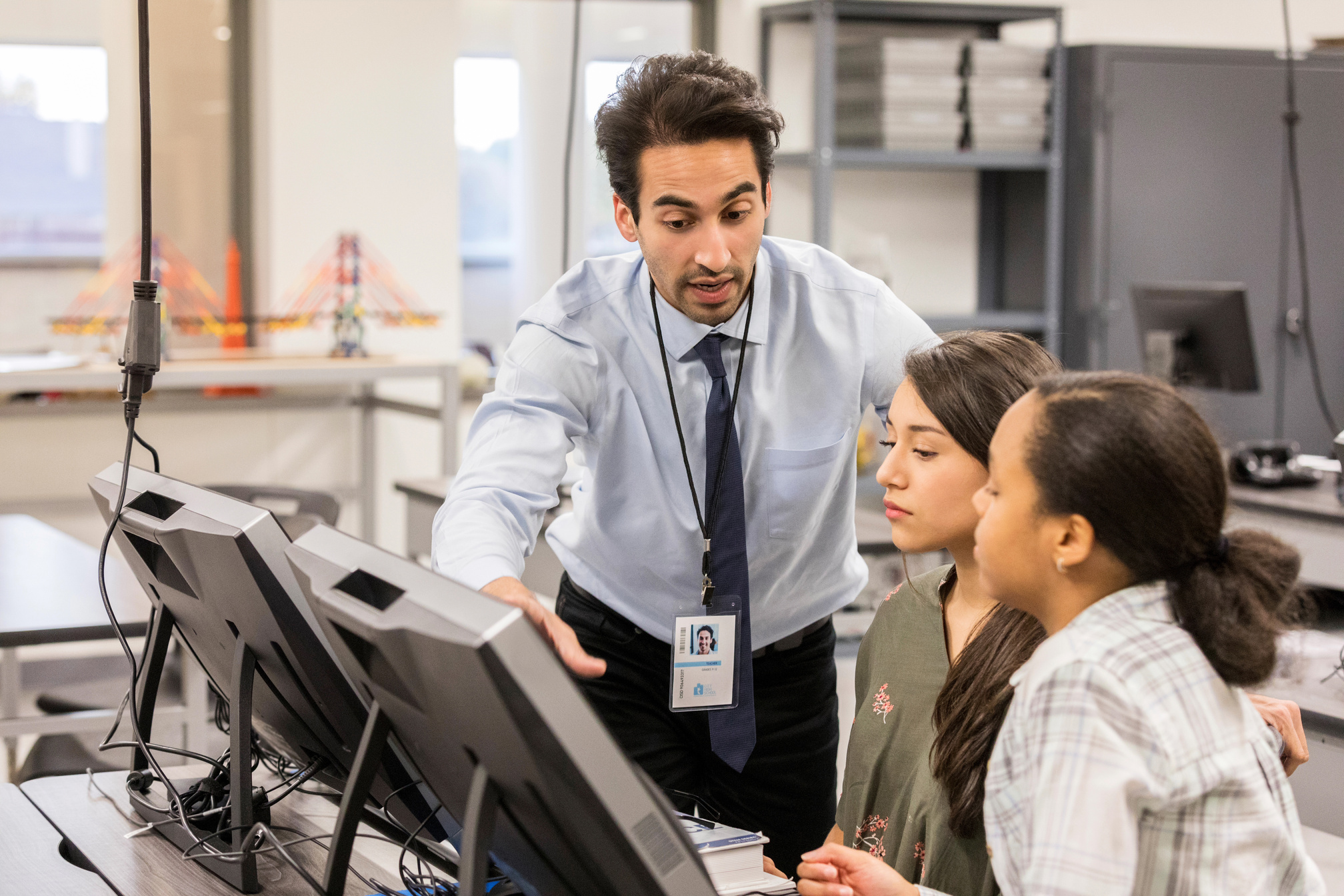 High school STEM teacher helping students